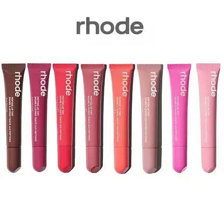 Set of Rhode lip balm tubes in various shades on a white background
